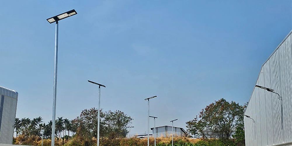 Solar street light pole and LED luminaire installed along an industrial park road for structural and foundation review