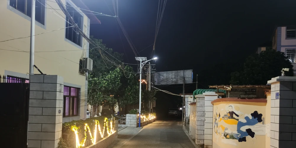 YY-80 solar street lights installed along a residential township street at night