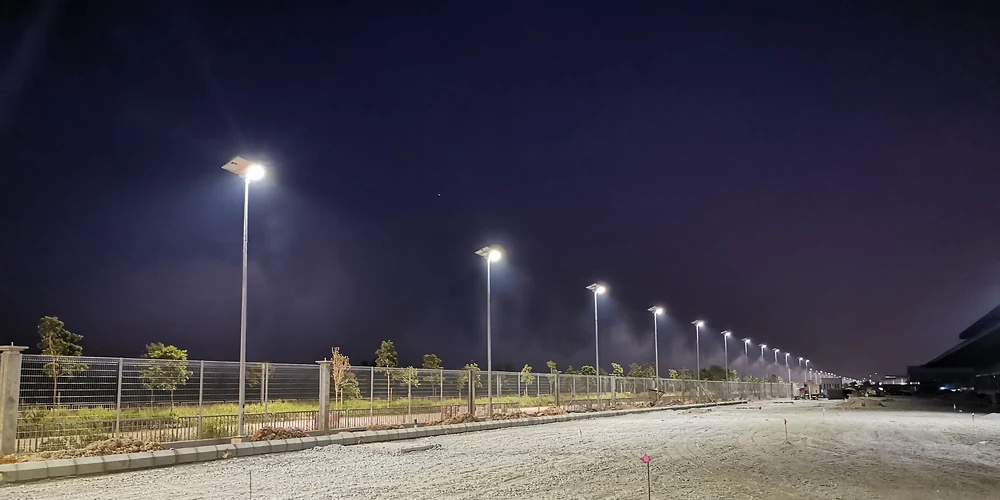 FH120 solar street lights illuminating an industrial park road in Malaysia at night