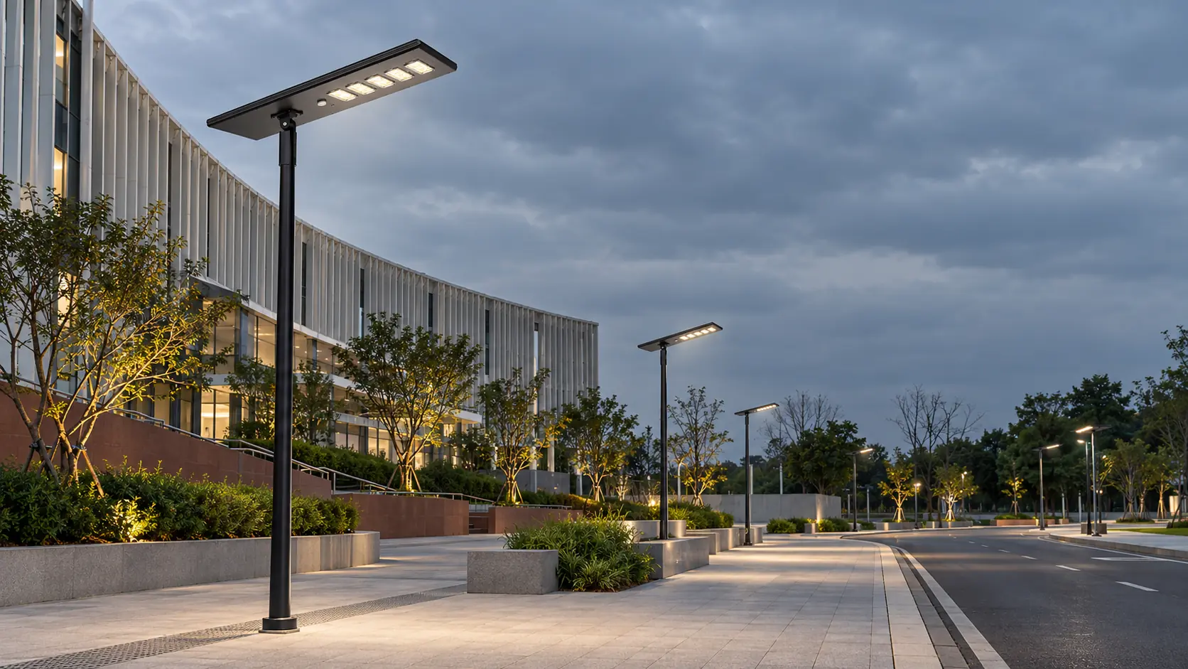 Solar street lights illuminating a modern campus road at dusk